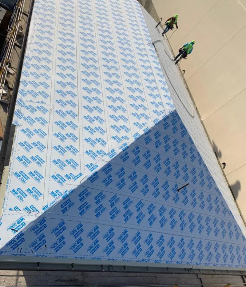 Professional roofers installing underlayment on a metal roof in Mount Lebanon